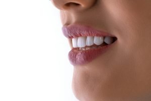 a close up of a woman's mouth with white teeth